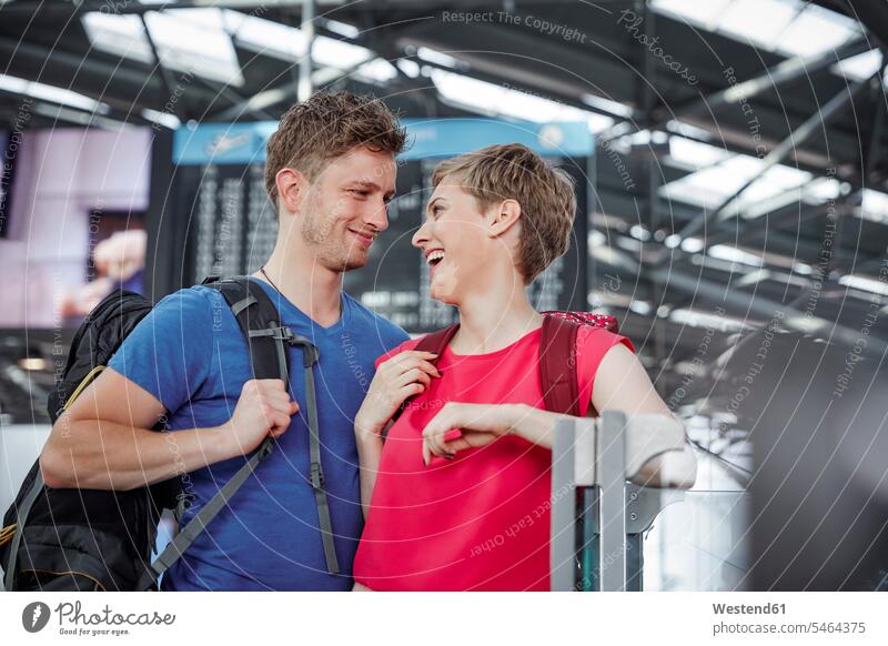 Happy couple at the airport twosomes partnership couples terminal airports happiness happy people persons human being humans human beings Germany departure