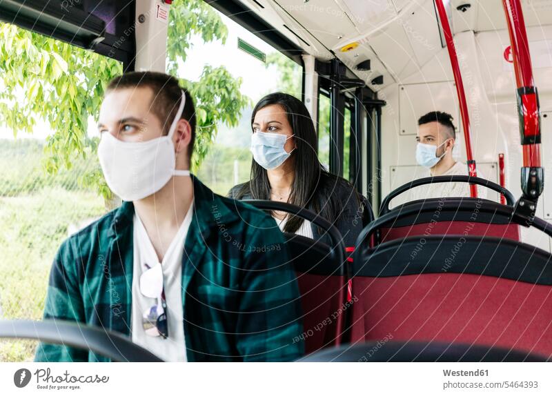 Portrait of woman wearing protective mask sitting in public bus looking out of window, Spain transport motor vehicles road vehicle road vehicles buses busses