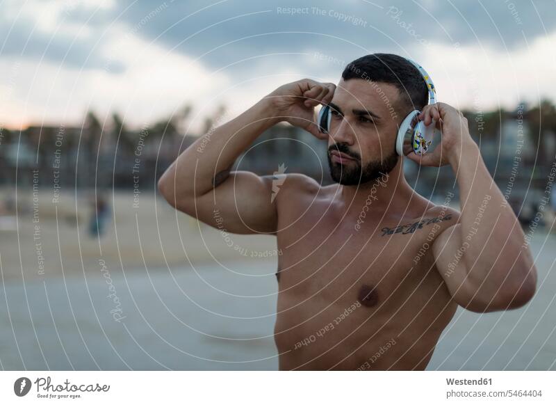 Portrait of barechested muscular man with headphones outdoors portrait portraits men males muscles athletic headset Adults grown-ups grownups adult people