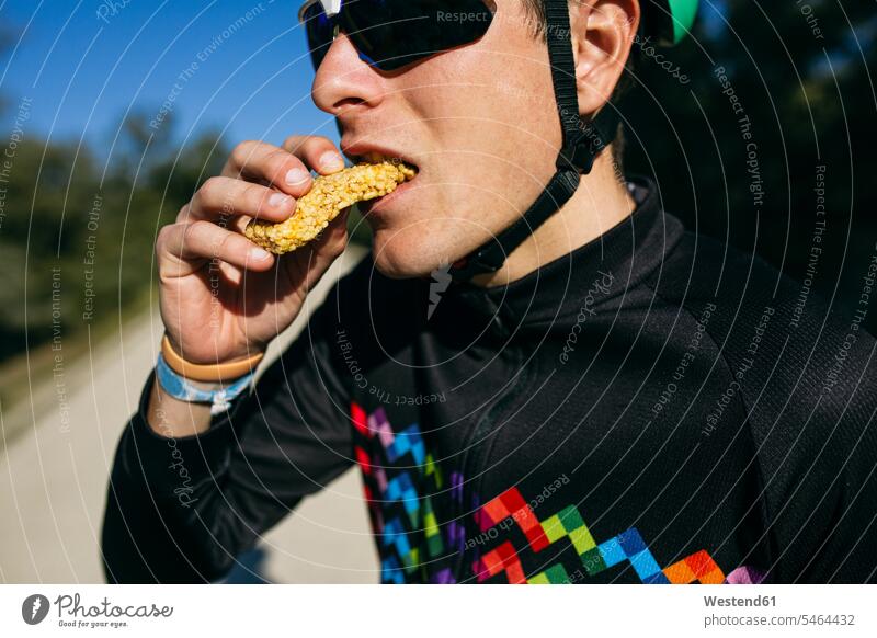 Portrait of cyclist eating a snack during a break on a sunny day bikes bicycles bike - bicycle Cycle Cycle - Vehicle Eye Glasses Eyeglasses specs spectacles