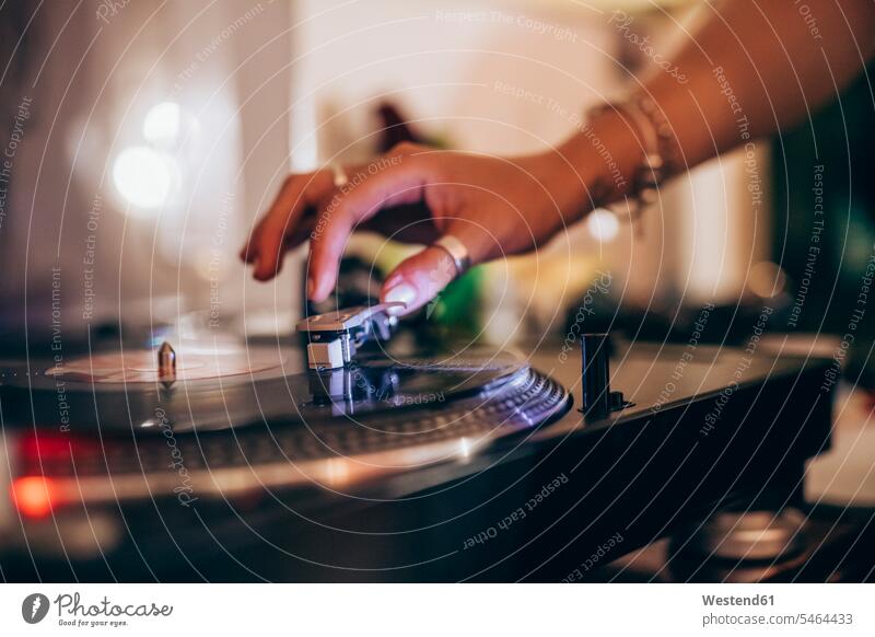 Cropped image of woman using turntable during party at home color image colour image indoors indoor shot indoor shots interior interior view Interiors
