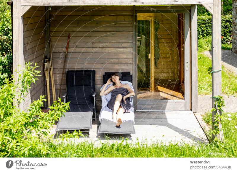 Woman relaxing on a lounge outside sauna human human being human beings humans person persons caucasian appearance caucasian ethnicity european 1