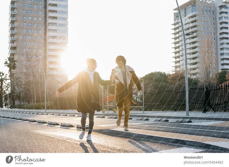 Happy couple running in the city at sunset happiness happy sunsets sundown twosomes partnership couples atmosphere atmospheric mood moody Atmospheric Mood Vibe