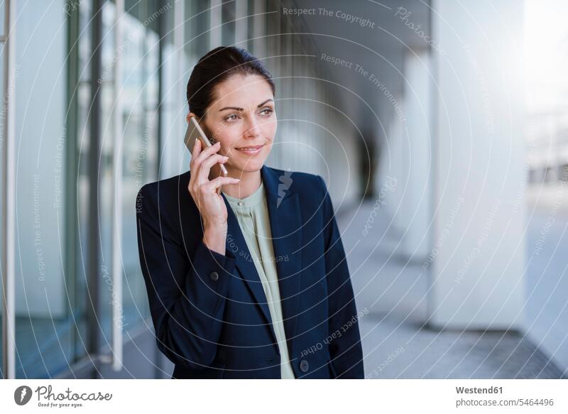 Portrait of smiling businesswaman on the phone businesswoman businesswomen business woman business women smile call telephoning On The Telephone calling