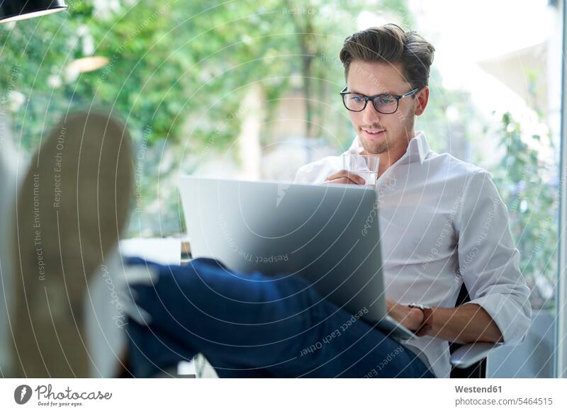 Portrait of smiling businessman using laptop in office human human being human beings humans person persons caucasian appearance caucasian ethnicity european 1