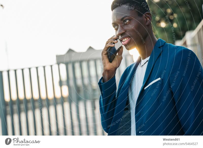 Young male professional on phone call outdoors color image colour image location shots outdoor shot outdoor shots day daylight shot daylight shots day shots