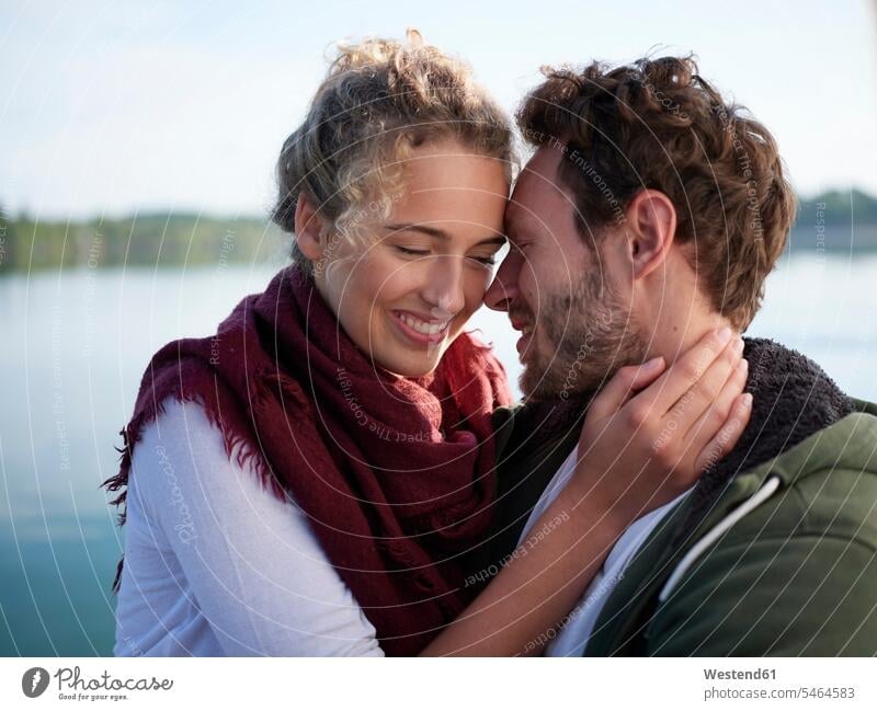 Romantioc couple kissing at lake kisses seasons spring season Spring Time springtime happy Emotions Feeling Feelings Sentiment Sentiments loving closeness