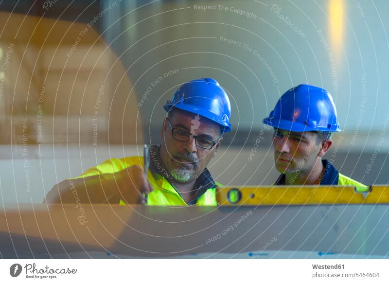 Engineers in industrial plant discussing work worker blue collar worker workers blue-collar worker industry engineer engineers factory plants factories