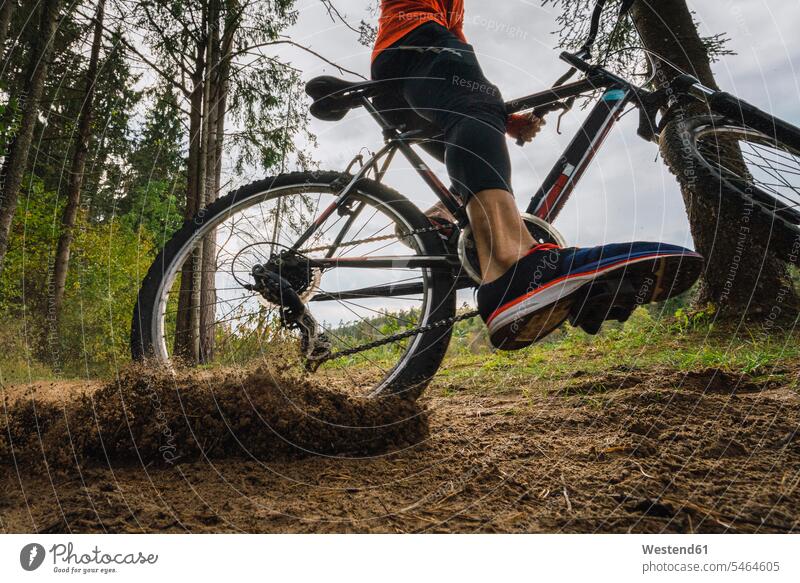 Athlete mountainbiking in the woods athlete Sportspeople Sportsman Sportsperson athletes Sportsmen riding mountain bike forest forests mountain biker