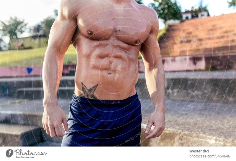 Mid-section of barechested muscular man outdoors men males muscles athletic Adults grown-ups grownups adult people persons human being humans human beings Spain
