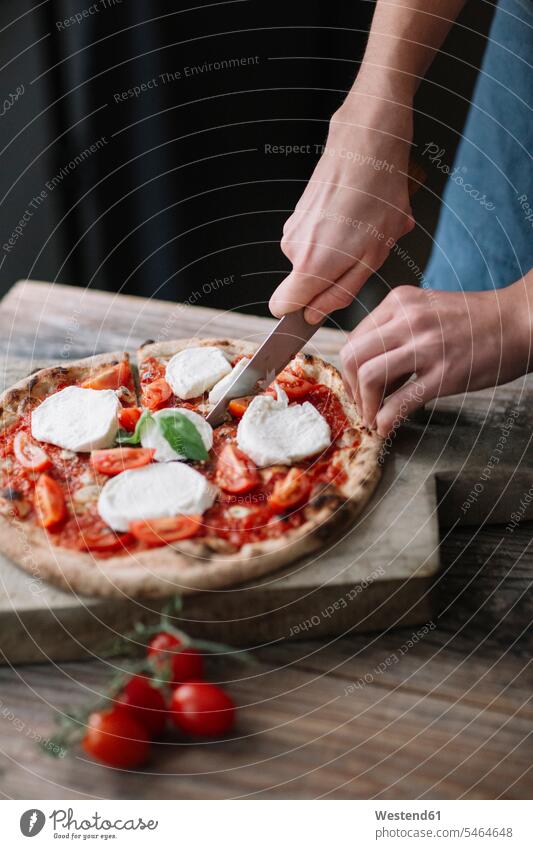 Young man preparing pizza, cutting pizza hand human hand hands human hands preparation prepare Pizza Pizzas Pizza Slice Pizza Slices men males knife knives