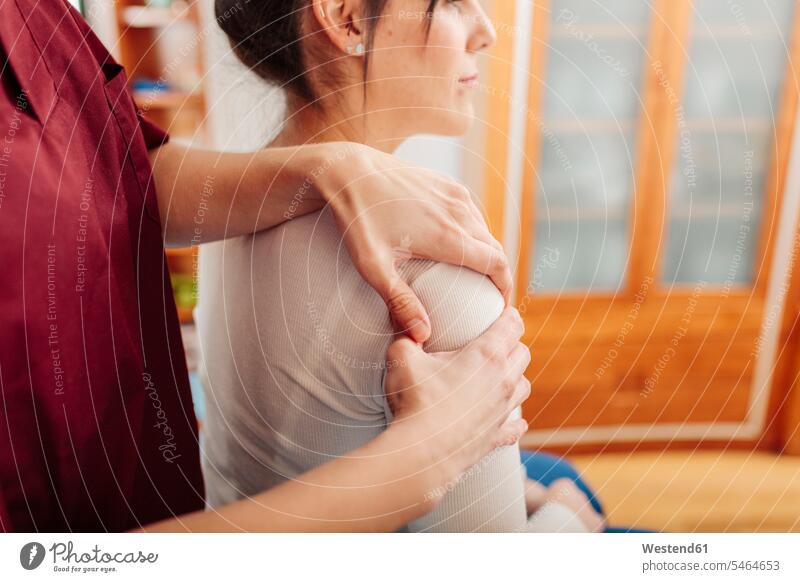 Physiotherapist massaging woman shoulder color image colour image indoors indoor shot indoor shots interior interior view Interiors day daylight shot