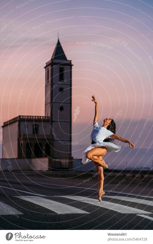 Ballerina dancing in front of a church in the evening exercise practising train training exercising practice practise Late Evening stand free time leisure time