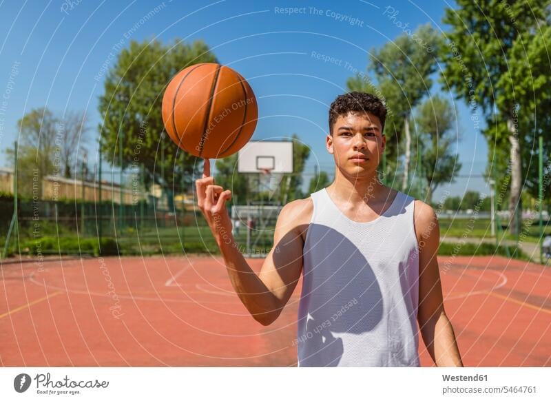 Young man playing with basketball balls playing field sports field Sports Court pitch fields court skill Ability skilled basketballs basketball ground