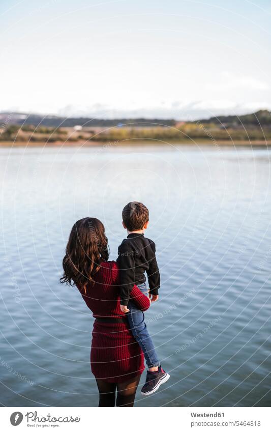 Mother and son looking at lake, rear view human human being human beings humans person persons caucasian appearance caucasian ethnicity european 2 2 people