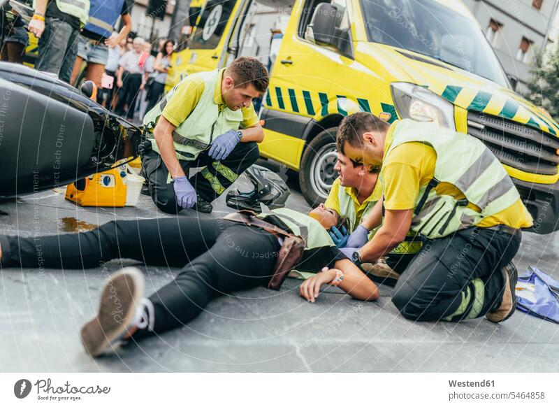 Paramedics helping crash victim after scooter accident Occupation Work job jobs profession professional occupation health healthcare Healthcare And Medicines