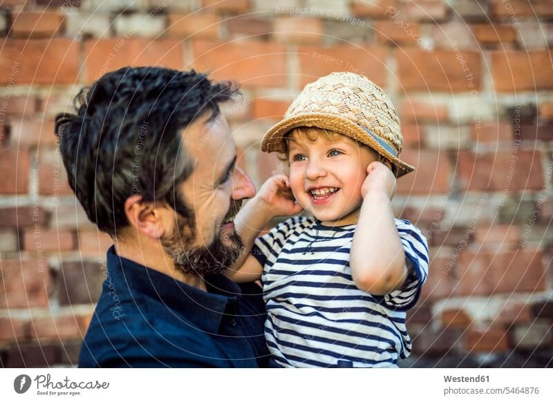 Portrait of happy toddler on his father's arms portrait portraits pa fathers daddy dads papa happiness toddlers infants toddler age Toddler parents family