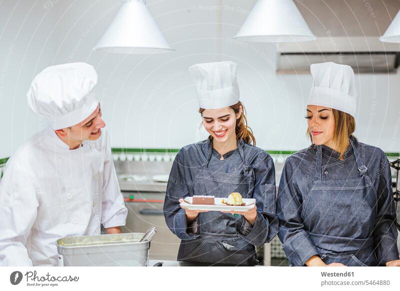Junior chef showing her prepaired dessert on plate human human being human beings humans person persons caucasian appearance caucasian ethnicity european Group
