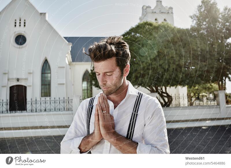 Portrait of man in old-fashioned clothes in the countryside praying at a church human human being human beings humans person persons caucasian appearance