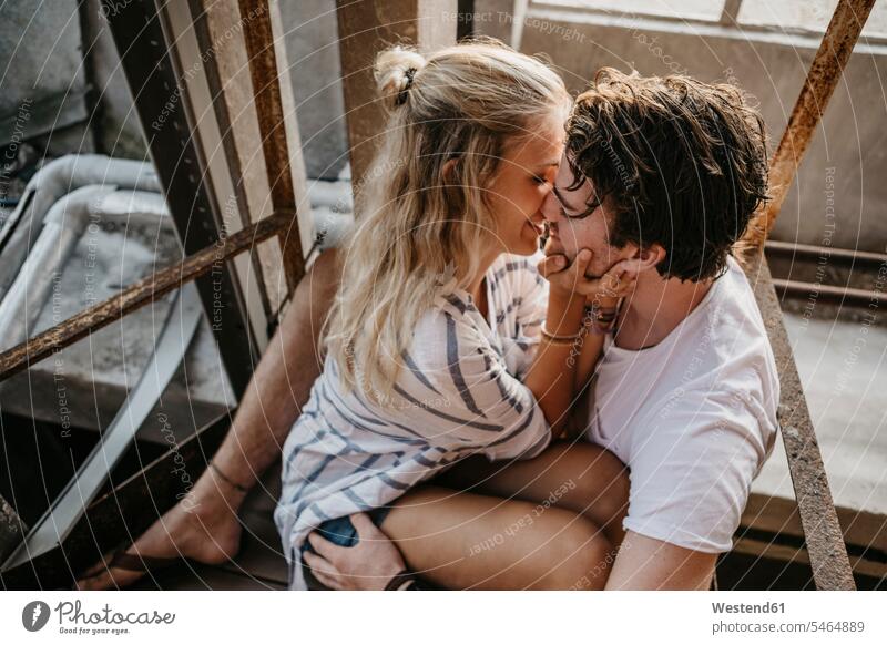 Young couple kissing in an old building kisses twosomes partnership couples buildings people persons human being humans human beings built structure