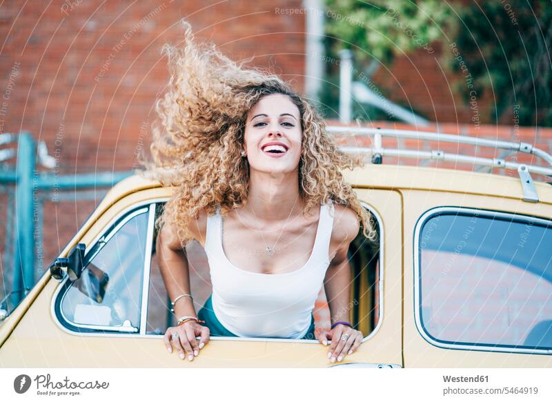 Portrait of blond woman leaning out of window of classic car tossing her hair hair toss Tossing Hair vintage car portrait portraits car window car windows