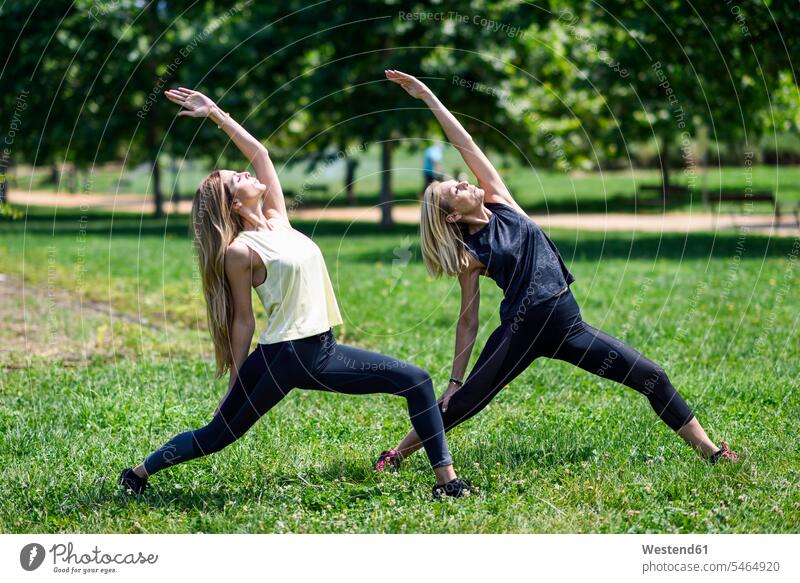 Mature woman doing yoga with her daughter in a park human human being human beings humans person persons caucasian appearance caucasian ethnicity european 2