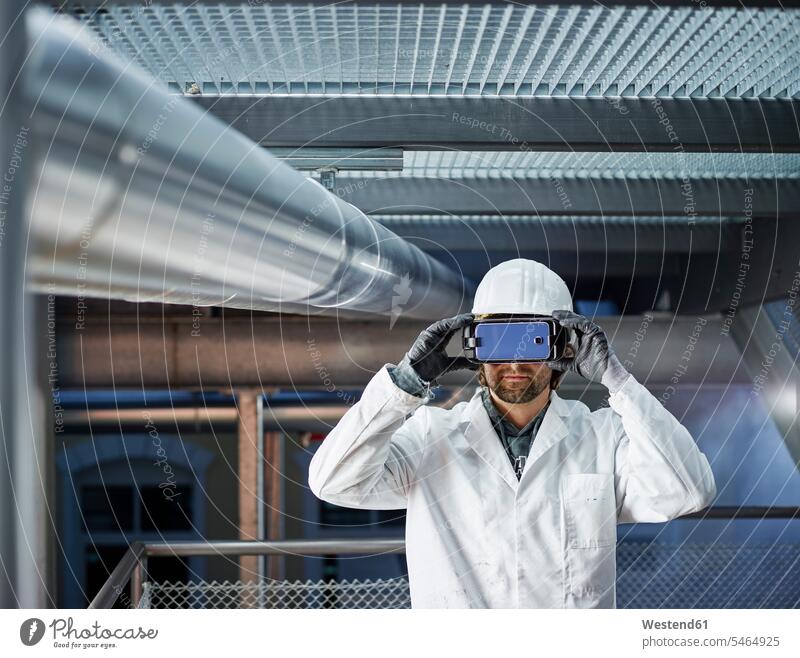 Technician with hard hat looking through VR glasses Virtual Reality Glasses Virtual-Reality Glasses virtual reality headset vr headset vr goggles