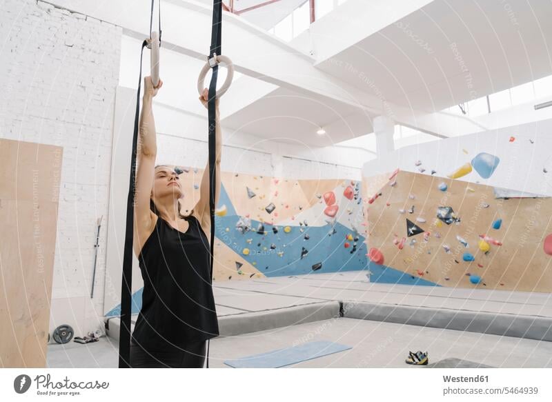 Woman doing stretching exercises before climbing on the wall (value=0) human human being human beings humans person persons caucasian appearance