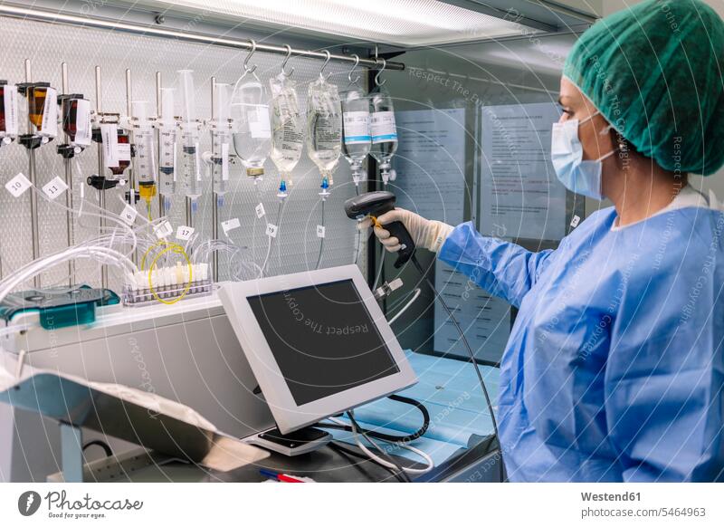 Female doctor scanning drips in laboratory color image colour image Spain indoors indoor shot indoor shots interior interior view Interiors