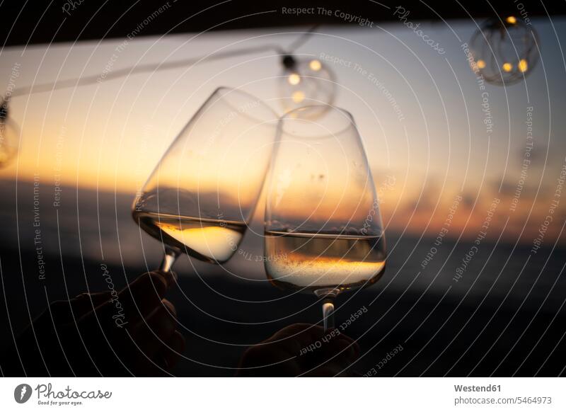 Woman holding two glasses of white wine in van at sunset Drinking Glass Drinking Glasses Wine Glasses Wineglass Wineglasses in the evening lyrical Romance