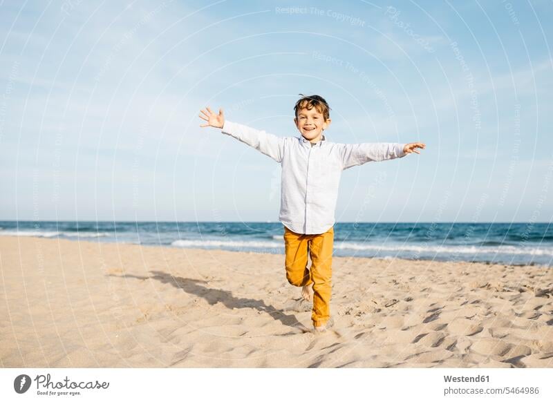 Portrait of happy little boy running on the beach Vitality Verve vigour vigorous Joy enjoyment pleasure Pleasant delight smiling smile portrait portraits