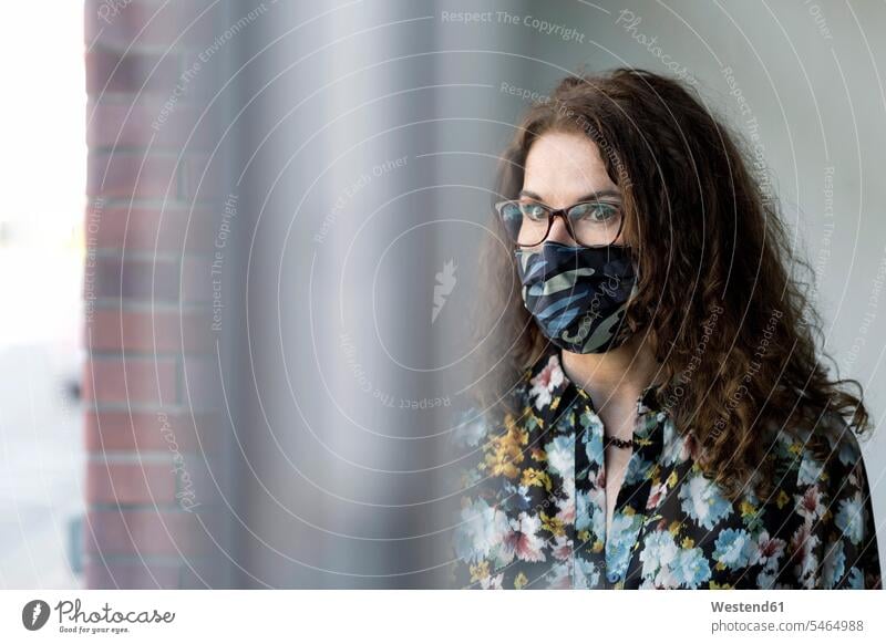 Woman wearing protective mask at window glass human human being human beings humans person persons caucasian appearance caucasian ethnicity european 1