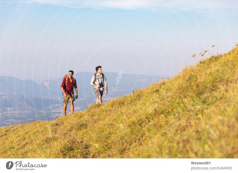 Italy, Monte Nerone, two men hiking in mountains in summer man males mountain range mountain ranges summer time summery summertime hike walking going hiker