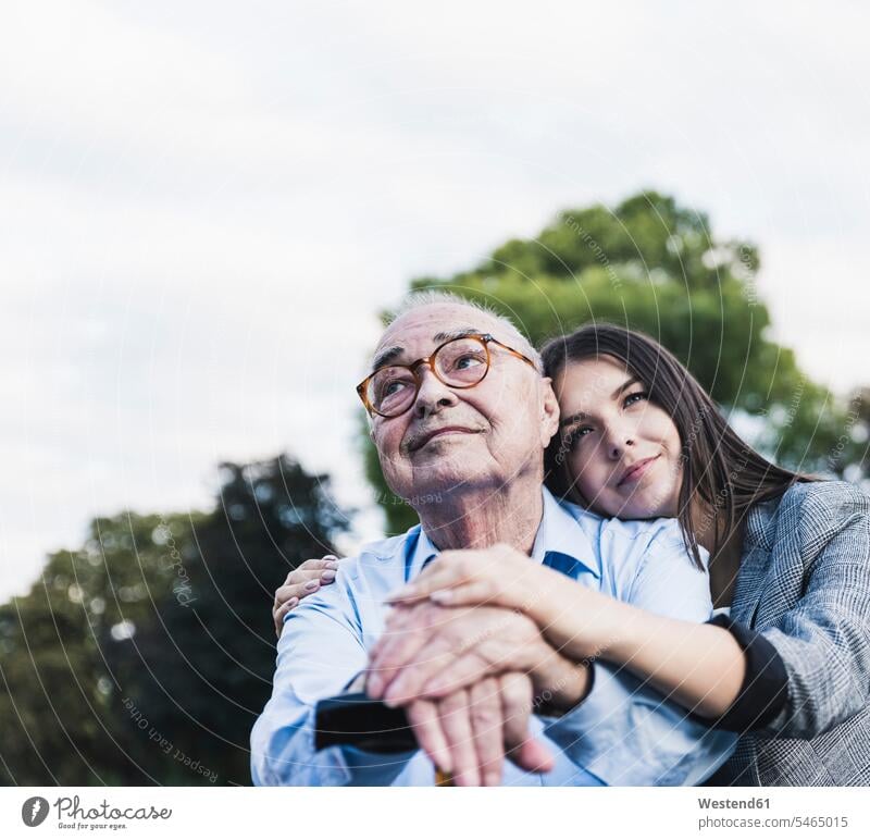 Portrait of senior man and his granddaughter in a park generation touch Emotions Feeling Feelings Sentiment Sentiments loving closeness propinquity free time