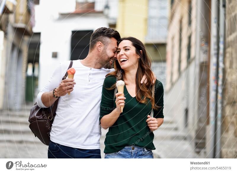 Happy tourist couple with ice cream cones in the city town cities towns tourists Ice Cream Cone ice-cream cone Ice Cream Cones ice-cream wafer twosomes