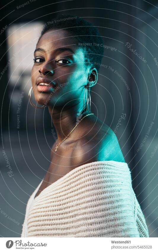 Portrait of self-confident young woman wearing earrings human human being human beings humans person persons African black black ethnicity coloured 1
