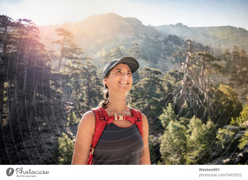 Female hiker during hike, Haute-Corse, Corsica, France back-pack back-packs backpacks rucksack rucksacks discover discovering smile wander wandering delight