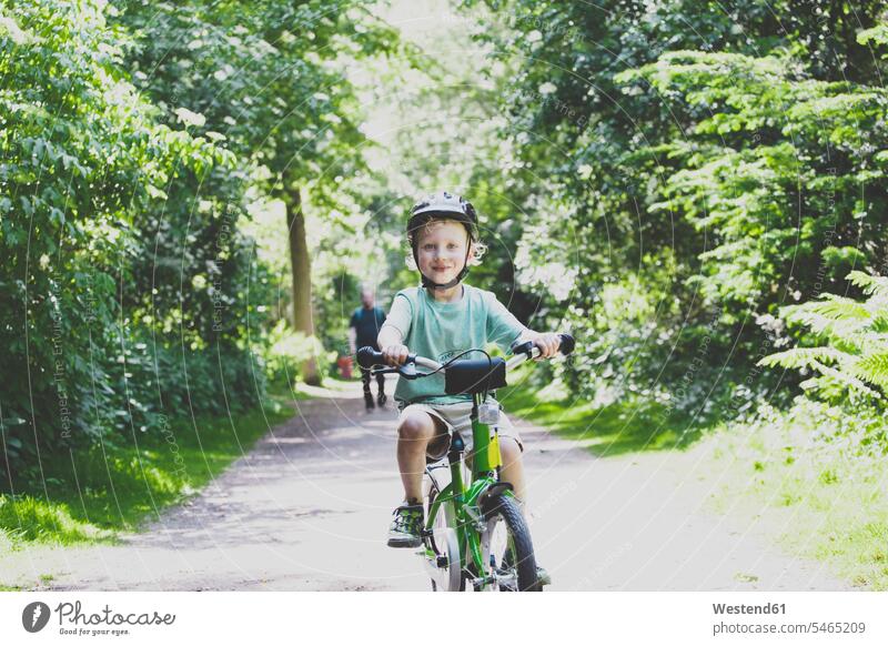 Portrait of proud little boy learning to ride bicycle human human being human beings humans person persons caucasian appearance caucasian ethnicity european 2