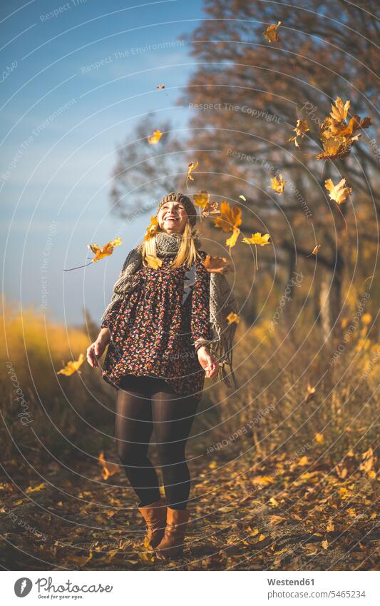 Happy pregnant woman standing on forest path playing with autumn leaves happiness happy autumn leaf forest track forest paths forest tracks Pregnant Woman