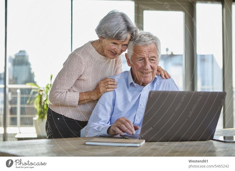 Portrait of smiling senior couple using laptop Laptop Computers laptops notebook smile use elder couples senior couples computer computers adult couple