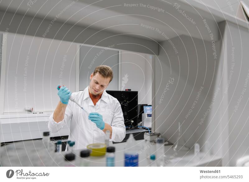 Scientist working with a pipette in laboratory human human being human beings humans person persons caucasian appearance caucasian ethnicity european 1