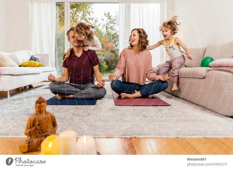 Exuberant girls with parents meditating at home human human being human beings humans person persons caucasian appearance caucasian ethnicity european Group