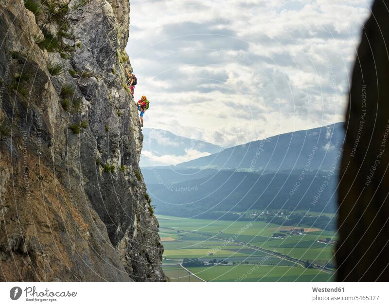 Austria, Tyrol, two rock climbers in Martinswand rock face rock wall escarpment rocks free climber Rock Climbers climbing man males extreme athlete