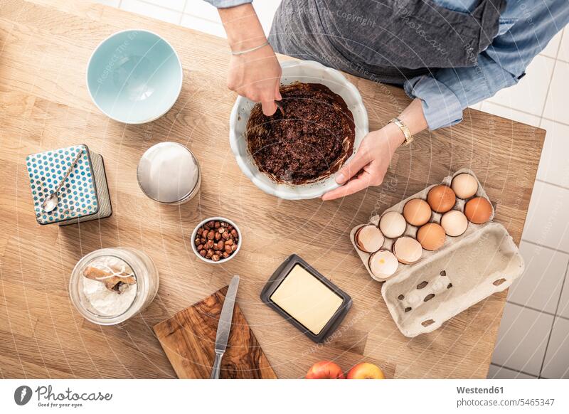 Woman mixing cake batter while standing at kitchen island color image colour image indoors indoor shot indoor shots interior interior view Interiors day