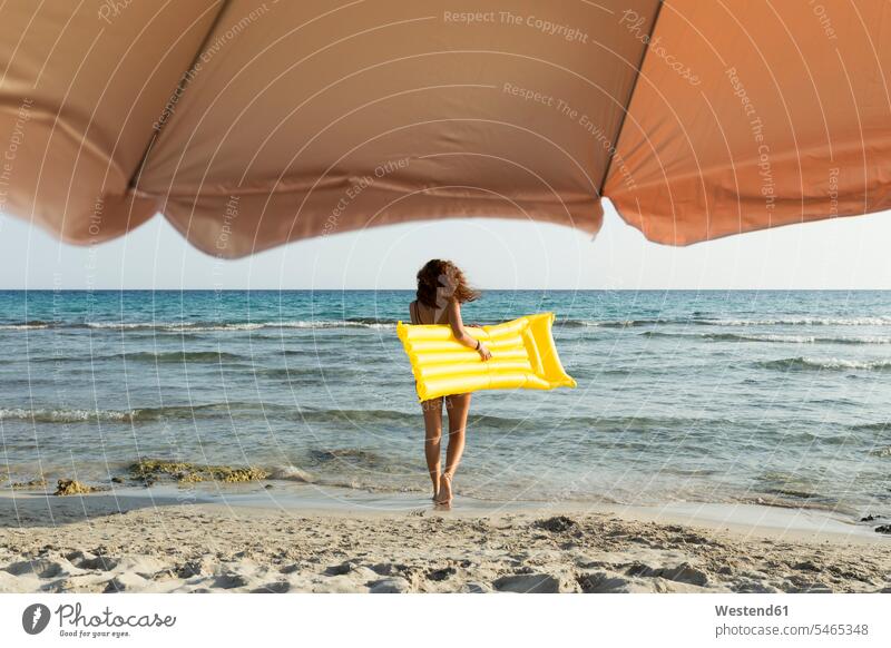 Young woman with yellow airbed at the beach air bed air beds air mattress air mattresses airbeds inflatable mattress lilo lilos bathe Taking A Bath go going