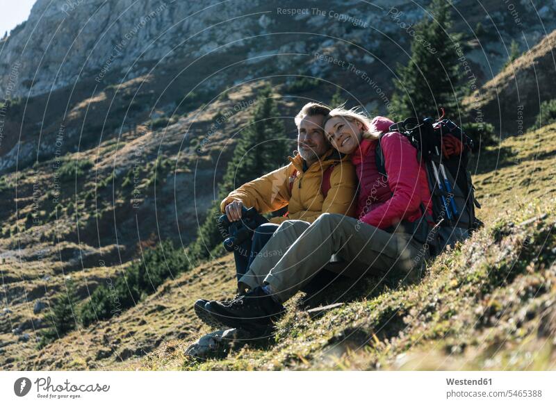 Austria, Tyrol, couple having a break during a hiking trip in the mountains mountain range mountain ranges hike twosomes partnership couples hiking tour