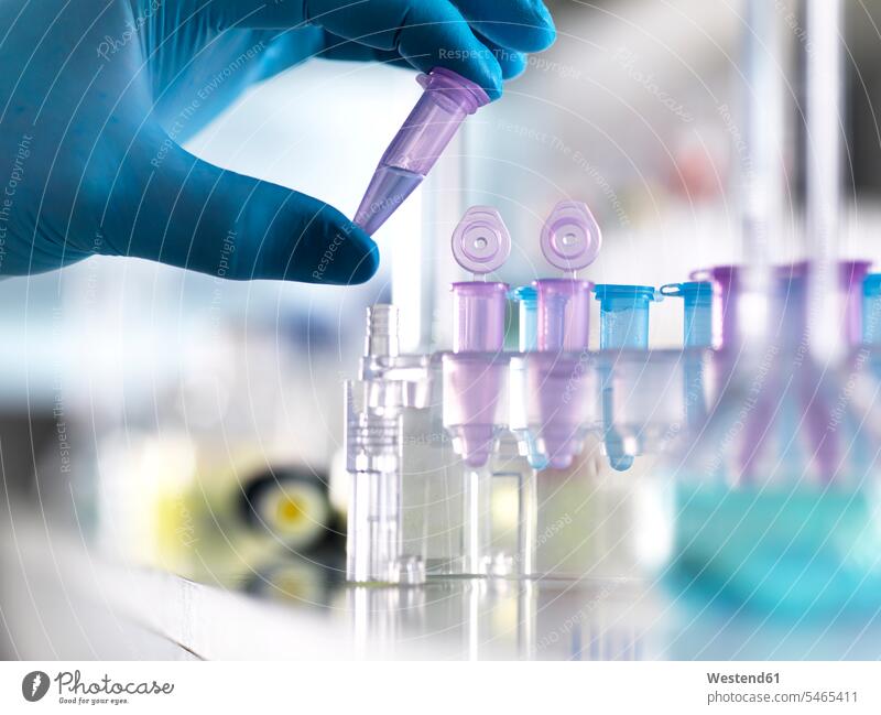 Cropped hand of male scientist holding DNA samples in vial at laboratory analysis analyzing analyse Analytics biochemistry bio-chemistry healthcare and medicine