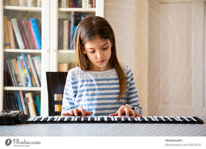 Girl playing roll piano at home T- Shirt t-shirts tee-shirt Instrument Instruments musical instruments pianos learn Seated sit exercise exercising practice