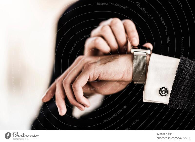 Businessman checking the time on his smartwatch Business man Businessmen Business men Checking The Time smart watch business people businesspeople