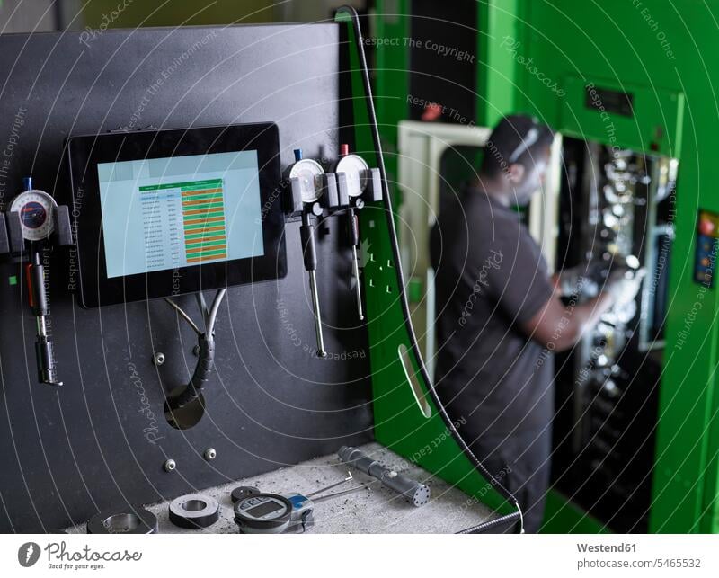 Man working on a machine African-American Ethnicity Afro-American African American Ethnicity African Americans Afro-Americans CNC Control controlling checking